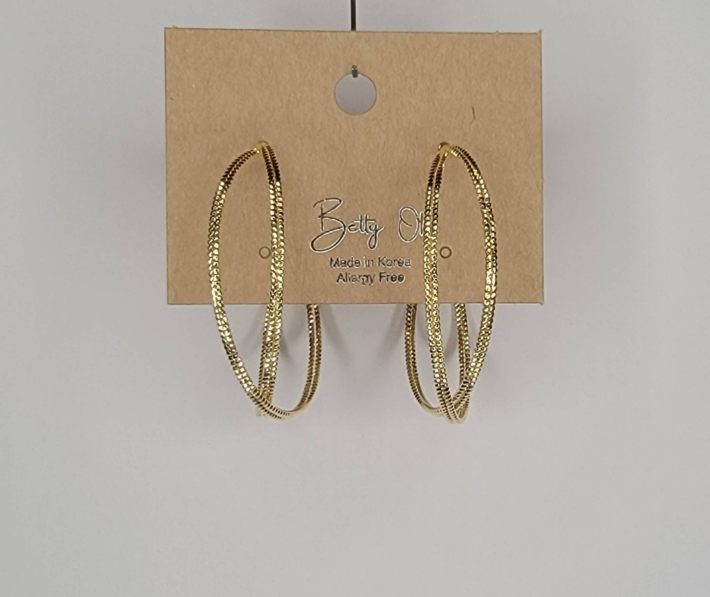 BETTYOH INC - LAZER CUT CRISS CROSS HOOP EARRINGS.