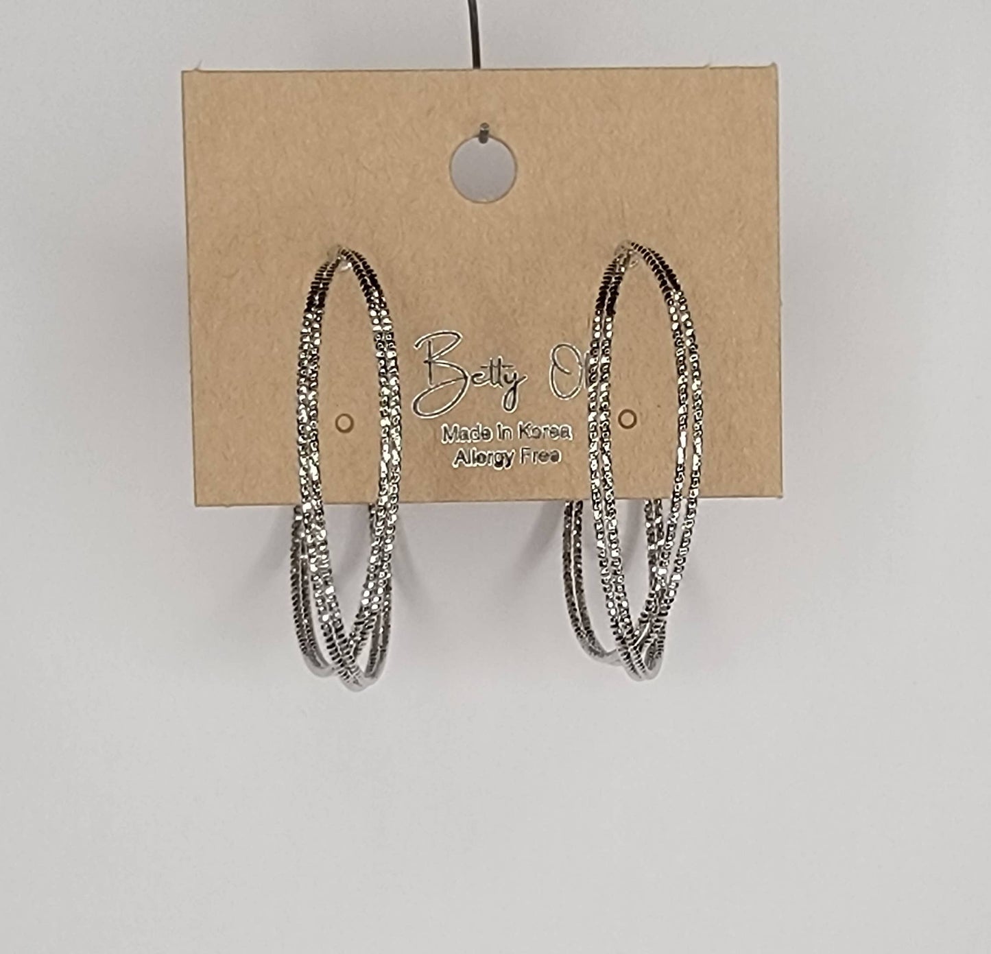 BETTYOH INC - LAZER CUT CRISS CROSS HOOP EARRINGS.